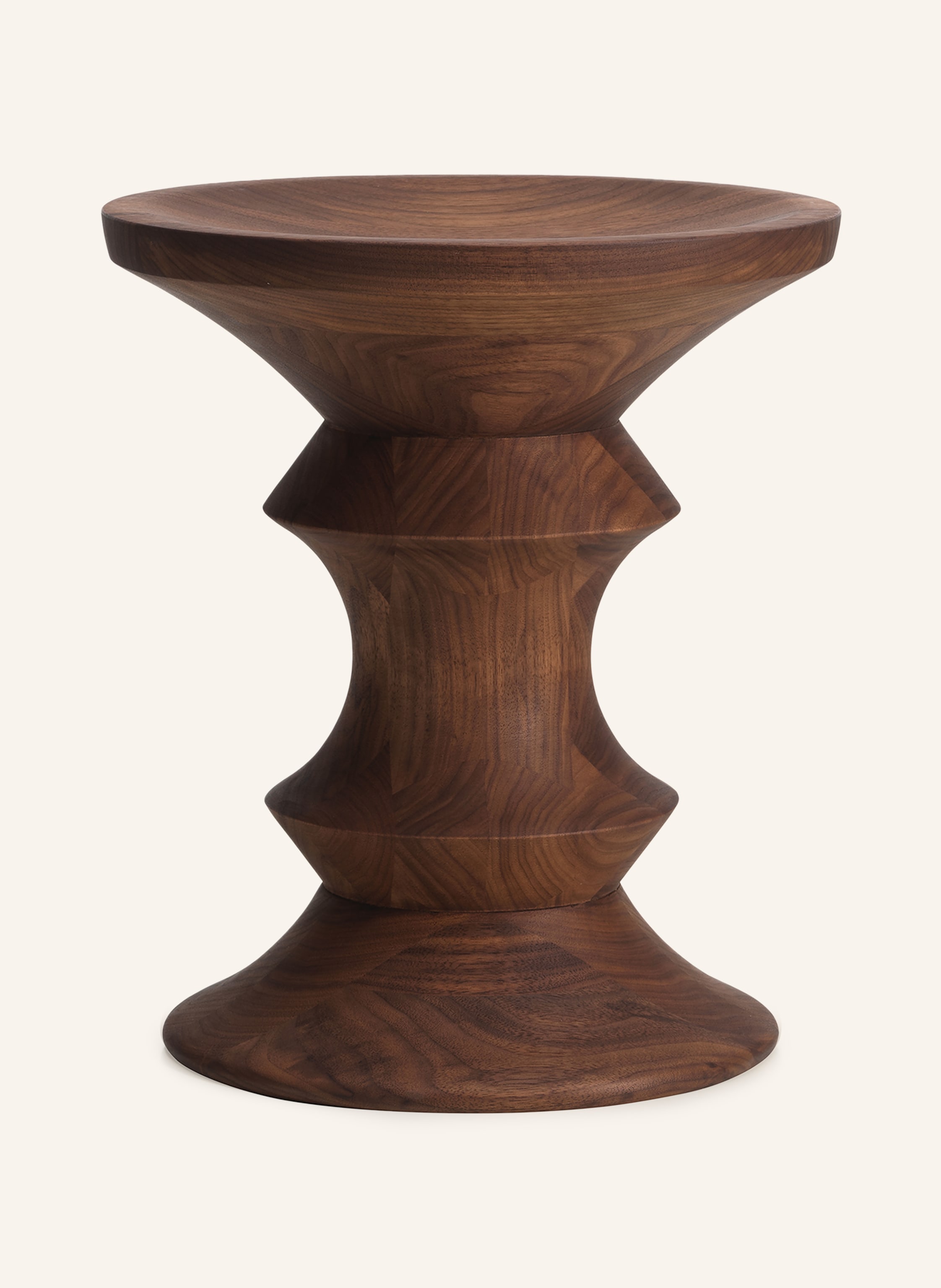 Vitra Eames Stool Model C aus massivem dunklem Nussbaum mit gedrechselter Taille und konkaver Sitzfläche, freigestellt